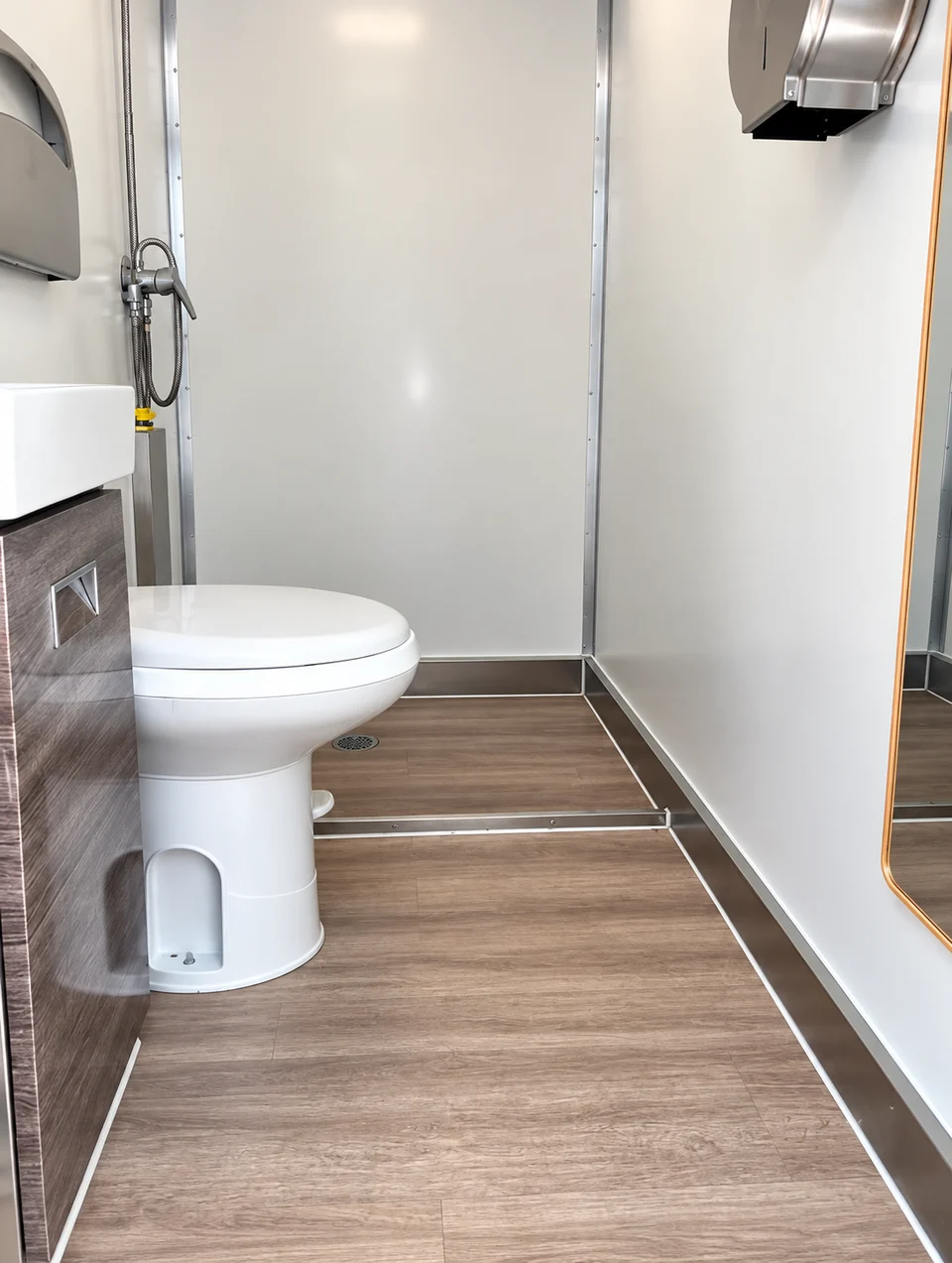 Toilet and shower enclosure inside a shower-restroom combination unit